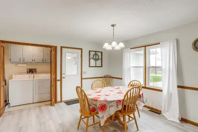a kitchen and dining room with a table and chairs at Quiet Greenwich Home with Pool and Screened Porch! in Greenwich