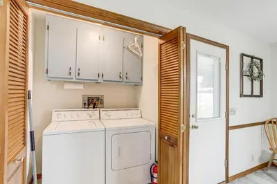 a laundry room with a washer and dryer at Quiet Greenwich Home with Pool and Screened Porch! in Greenwich