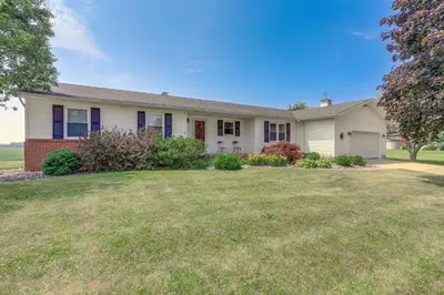 a large white house with a yard at Quiet Greenwich Home with Pool and Screened Porch! in Greenwich