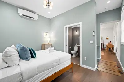 a bedroom with a white bed and a bathroom at 1BR with Kitchen & Free Parking - Walk Everywhere in Covington