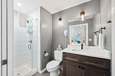 a bathroom with a toilet and a sink and a shower at 1BR with Kitchen & Free Parking - Walk Everywhere in Covington