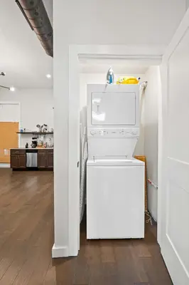 a white refrigerator in a room with a kitchen at 1BR with Parking - Walk to Convention Center & Stadiums in Covington