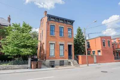 a red brick building on the corner of a street at 1BR with Parking - Walk to Convention Center & Stadiums in Covington