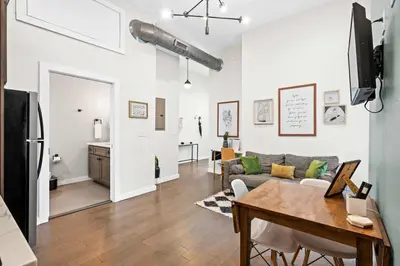 a living room with a couch and a table at 1BR with Parking - Walk to Convention Center & Stadiums in Covington
