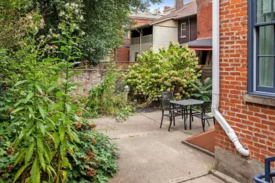 a patio with a table and chairs in a yard at Downtown Views - Walk to Stadiums & Convention Center in Covington
