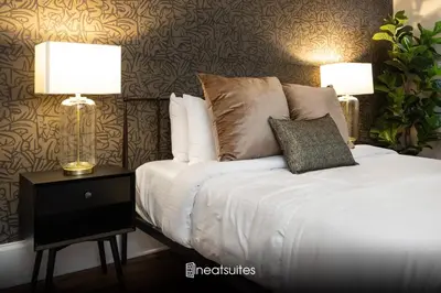 a bedroom with a bed with two lamps on a night stand at Walk to Downtown, Bars, Stadiums - Perfect for 4! in Covington