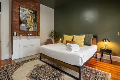 a bedroom with a large white bed in a room at Walk to Downtown, Bars, Stadiums - Perfect for 4! in Covington