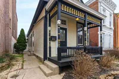 a small house with a black and white facade at Walk to Downtown, Bars, Stadiums - Perfect for 4! in Covington