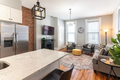 an open kitchen and living room with a counter top at Main Street 2BR, Walk to Bars, Stadiums, Downtown in Covington