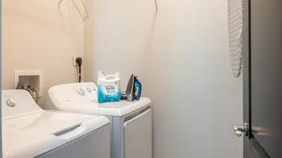 a white bathroom with a sink and a mirror at Downtown Covington - Near Shopping, Bars, Cincinnati in Covington