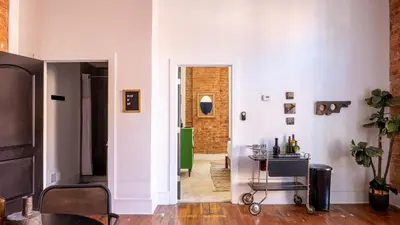 a room with a hallway with white walls and a table at Downtown Covington - Near Shopping, Bars, Cincinnati in Covington