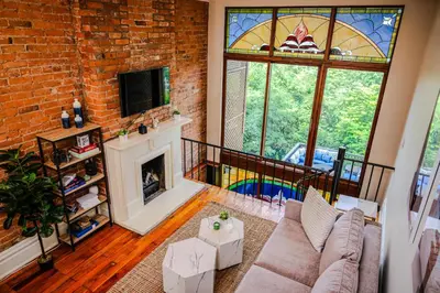 a living room with a fireplace and a stained glass window at 4BR Bridal, Group Retreat - Walkable - Skyline Views in Cincinnati