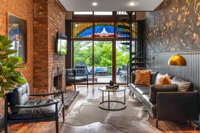 a living room with a couch and a stained glass window at 4BR Bridal, Group Retreat - Walkable - Skyline Views in Cincinnati