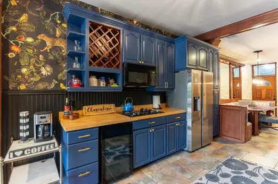 a kitchen with blue cabinets and a refrigerator at 4BR Bridal, Group Retreat - Walkable - Skyline Views in Cincinnati