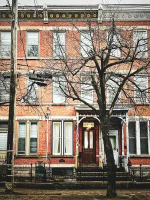 a brick building with a tree in front of it at 4BR Bridal, Group Retreat - Walkable - Skyline Views in Cincinnati
