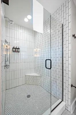 a bathroom with a shower with white tiled walls at Clawfoot Tub, Next to Monastery Wedding Venue, 3BR in Cincinnati