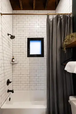 a bathroom with a bath tub and a window at 1BR Downtown, Close to Cincinnati Stadiums & Bars in Covington