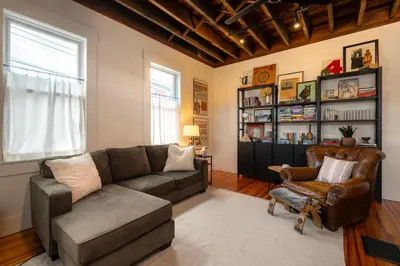 a living room with a couch and a chair at 1BR Downtown, Close to Cincinnati Stadiums & Bars in Covington