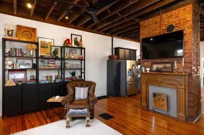 a living room with a chair and a fireplace at 1BR Downtown, Close to Cincinnati Stadiums & Bars in Covington