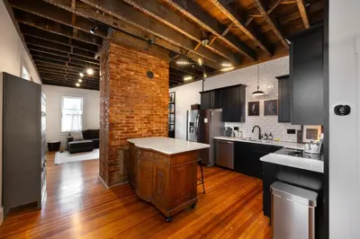 a kitchen with a counter in the middle of a room at 1BR Downtown, Close to Cincinnati Stadiums & Bars in Covington
