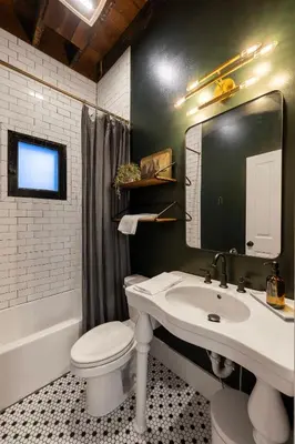 a bathroom with a sink and a toilet and a mirror at 1BR Downtown, Close to Cincinnati Stadiums & Bars in Covington