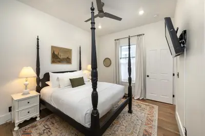a bedroom with a bed and a flat screen tv at 1BR Downtown, Close to Cincinnati Stadiums & Bars in Covington