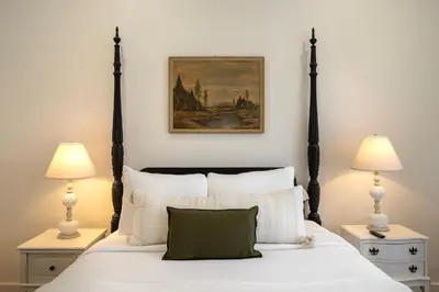 a bedroom with a large white bed with two lamps at 1BR Downtown, Close to Cincinnati Stadiums & Bars in Covington