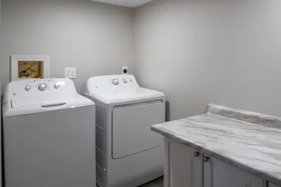 a kitchen with two white appliances and a counter at 2BR Townhome with Parking - Walk to Stadiums & Downtown in Covington
