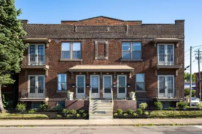 a red brick building with stairs in front at 2BR Townhome with Parking - Walk to Stadiums & Downtown in Covington