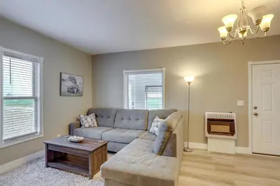 a living room with a couch and a table at Peaceful Shiloh Home with Deck and Fishing Pond Access in Shiloh
