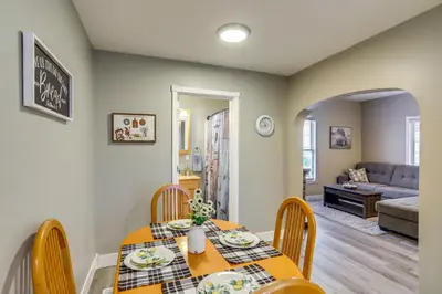 a dining room and living room with a table and chairs at Peaceful Shiloh Home with Deck and Fishing Pond Access in Shiloh