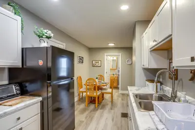 a kitchen with a black refrigerator and a table at Peaceful Shiloh Home with Deck and Fishing Pond Access in Shiloh