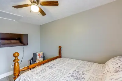 a bedroom with a bed with a ceiling fan at Peaceful Shiloh Home with Deck and Fishing Pond Access in Shiloh