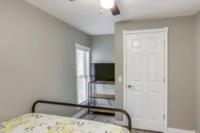a bedroom with a bed and a white door at Peaceful Shiloh Home with Deck and Fishing Pond Access in Shiloh