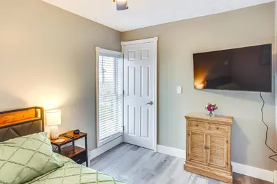 a bedroom with a bed and a flat screen tv at Peaceful Shiloh Home with Deck and Fishing Pond Access in Shiloh