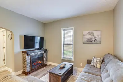 a living room with a couch and a fireplace at Peaceful Shiloh Home with Deck and Fishing Pond Access in Shiloh