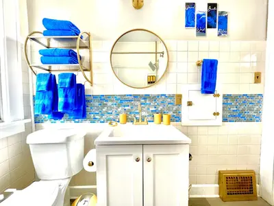 a bathroom with a toilet and a sink and a mirror at The Sapphire Haven - Your Old Brooklyn Oasis Awaits Families, Couples, Business Travelers Near Downtown With Parking, 300 MB WiFi & Self Check-In in Cleveland