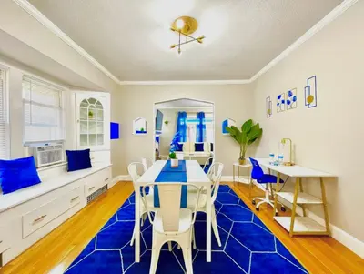 a blue and white dining room with a table and chairs at The Sapphire Haven - Your Old Brooklyn Oasis Awaits Families, Couples, Business Travelers Near Downtown With Parking, 300 MB WiFi & Self Check-In in Cleveland
