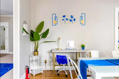a room with a desk and a table with a potted plant at The Sapphire Haven - Your Old Brooklyn Oasis Awaits Families, Couples, Business Travelers Near Downtown With Parking, 300 MB WiFi & Self Check-In in Cleveland