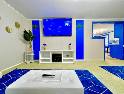 a living room with a white bed and blue walls at The Sapphire Haven - Your Old Brooklyn Oasis Awaits Families, Couples, Business Travelers Near Downtown With Parking, 300 MB WiFi & Self Check-In in Cleveland