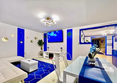 a blue and white living room with a table and chairs at The Sapphire Haven - Your Old Brooklyn Oasis Awaits Families, Couples, Business Travelers Near Downtown With Parking, 300 MB WiFi & Self Check-In in Cleveland
