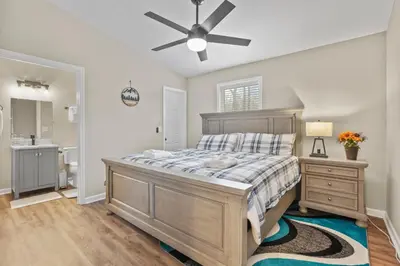a bedroom with a bed and a ceiling fan at Cabin with King Bed , XBOX, HotTub, Games, Firepit , Stargazing Dome in Logan