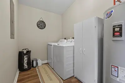 a small laundry room with a washer and dryer at Cabin with King Bed , XBOX, HotTub, Games, Firepit , Stargazing Dome in Logan