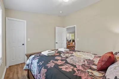 a bedroom with a bed with two towels on it at Cabin with King Bed , XBOX, HotTub, Games, Firepit , Stargazing Dome in Logan