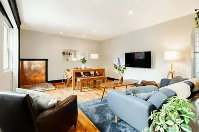 a living room with a couch and a table at Lux Parkside 1BR - Patio - Sun Deck - Free Parking in Cincinnati