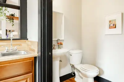 a bathroom with a white toilet and a sink at Lux Parkside 1BR - Patio - Sun Deck - Free Parking in Cincinnati