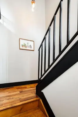 a staircase in a room with a picture on the wall at Lux Parkside 1BR - Patio - Sun Deck - Free Parking in Cincinnati