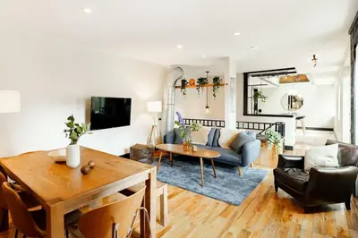 a living room with a couch and a table at Lux Parkside 1BR - Patio - Sun Deck - Free Parking in Cincinnati