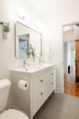 a white bathroom with a sink and a mirror at Soaring 2BR Parkside Loft Walkable to it All in Cincinnati