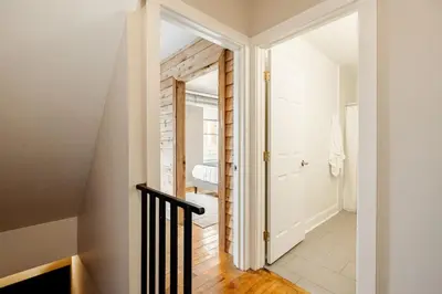 a hallway with a door leading to a bathroom at Soaring 2BR Parkside Loft Walkable to it All in Cincinnati